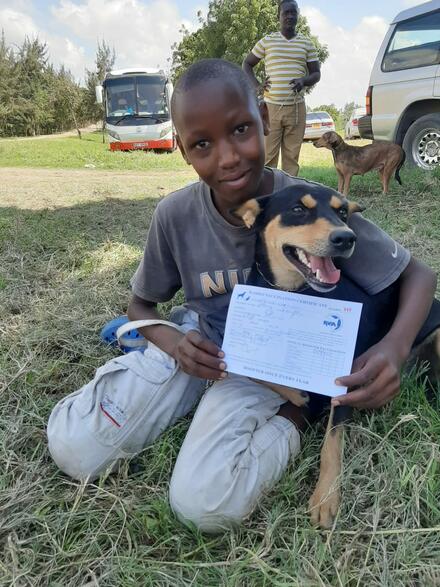 Child with dog and vaccination certificate
