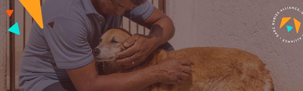 Man comforting a dog