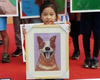 The girl with her "Happy dog" painting that inspired it all