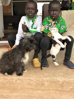 Brothers Ima (left) and Tony (right) bring their puppies to Gatbany Veterinary Clinic in Juba, for vaccination and to learn about looking after pets.