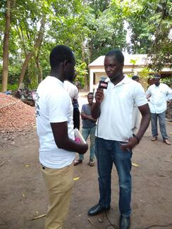 an executive member of the association having an interview with the state television journalist.