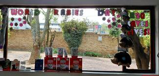 Donation display at Menlyn Vet Practice. A large window that reads 'World Rabies Day R20 saves lives' with pawprints representing each donated vaccination