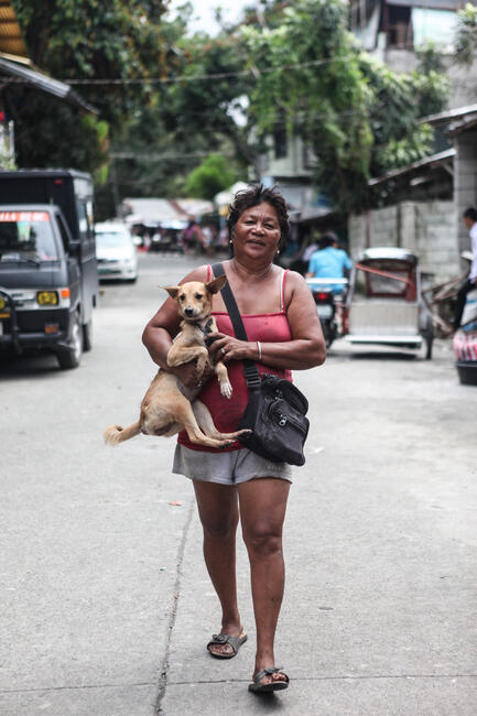 Woman bringing her dog to an MDV in the Philippines