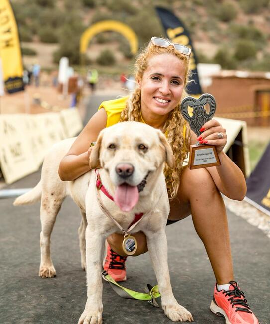 Sara Benhabbari with dog after Marathon. Rabies Ambassador 2024