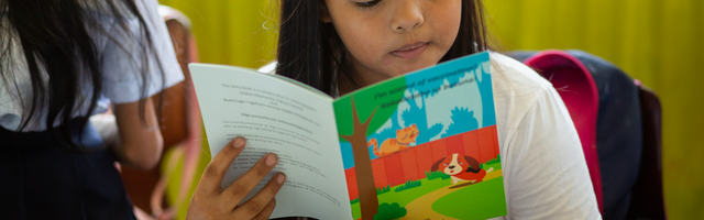 Girl reading GARC storybook
