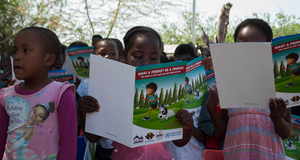 Children reading educational booklets